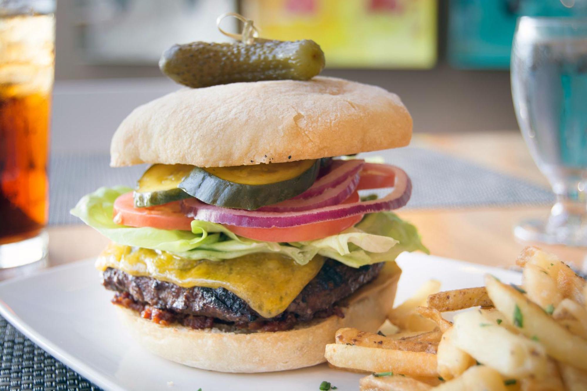 Hotel Murano Τακόμα Εξωτερικό φωτογραφία A cheeseburger with lettuce, tomato, onion, and pickle
